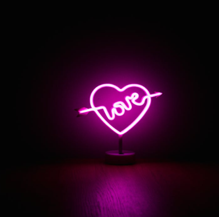 Heart-shaped neon lights with love written on it