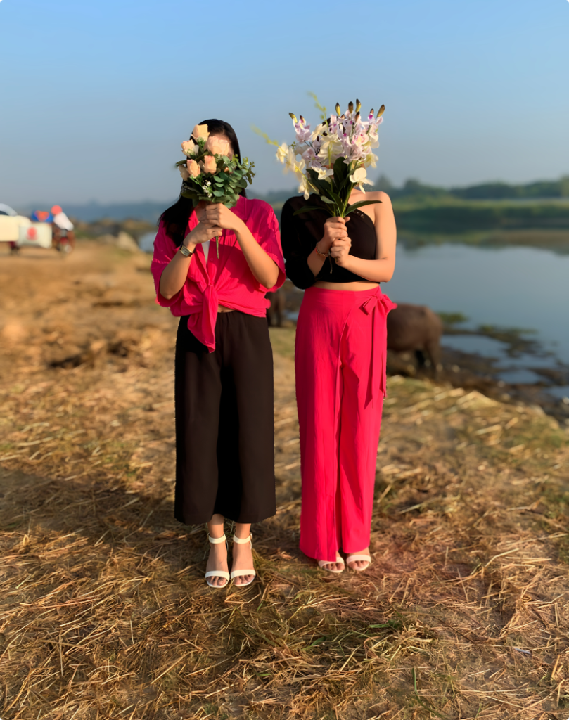 Sisters outdoor photoshoot covering their faces with flowers